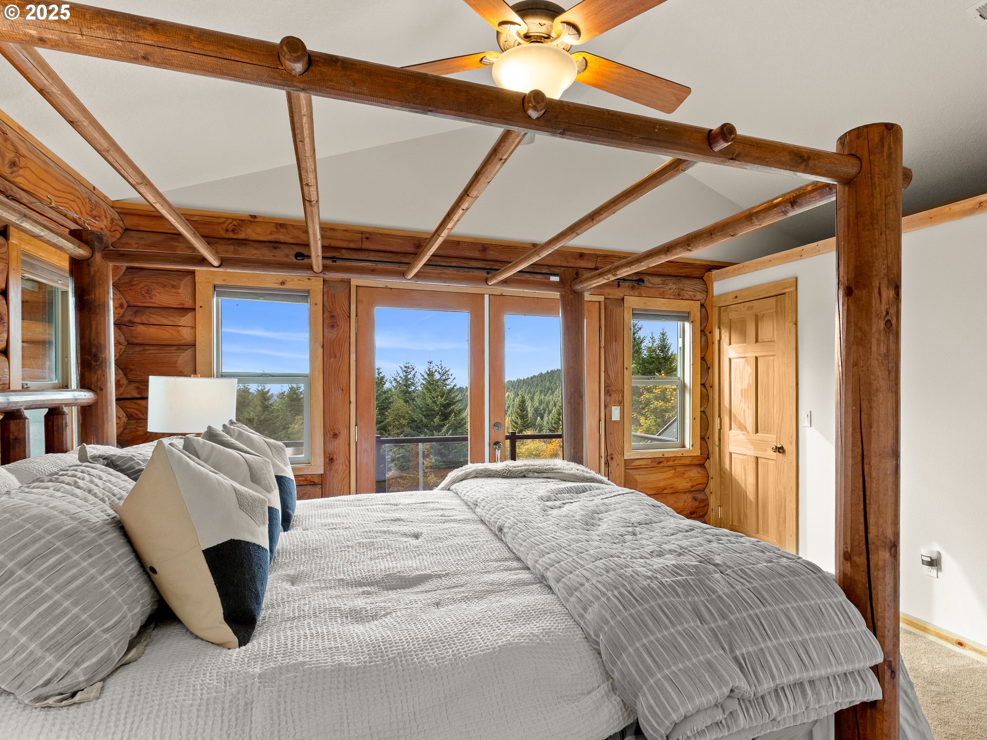 25520 Northeast 58th Street Vancouver, WA 98682 - Photo 24 of 48 a bedroom with a bed and large windows