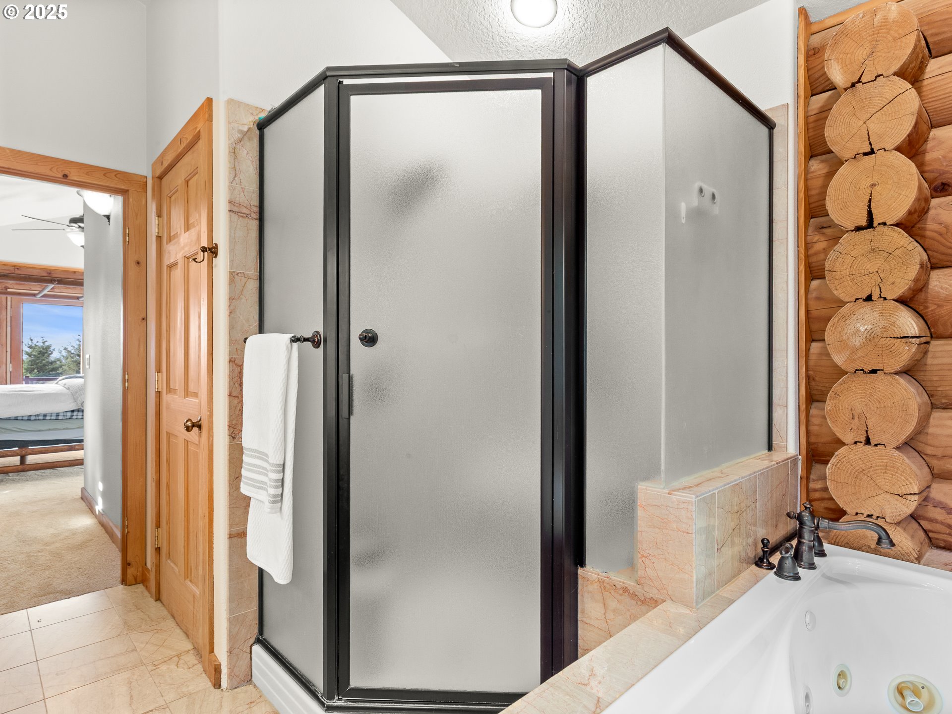 25520 Northeast 58th Street Vancouver, WA 98682 - Photo 27 of 48 a view of a bathroom with a glass door shower and a sink