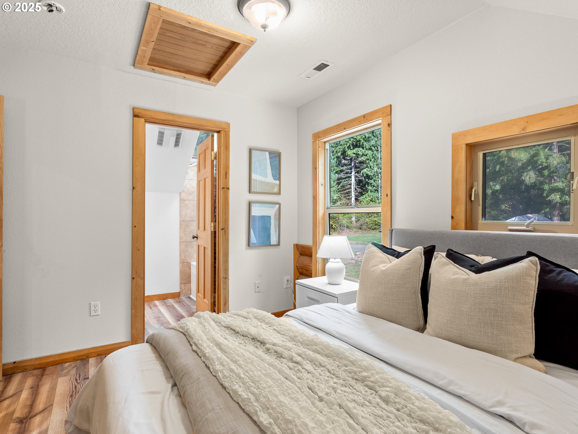 25520 Northeast 58th Street Vancouver, WA 98682 - Photo 29 of 48 a bedroom with a bed and a large mirror next to a window