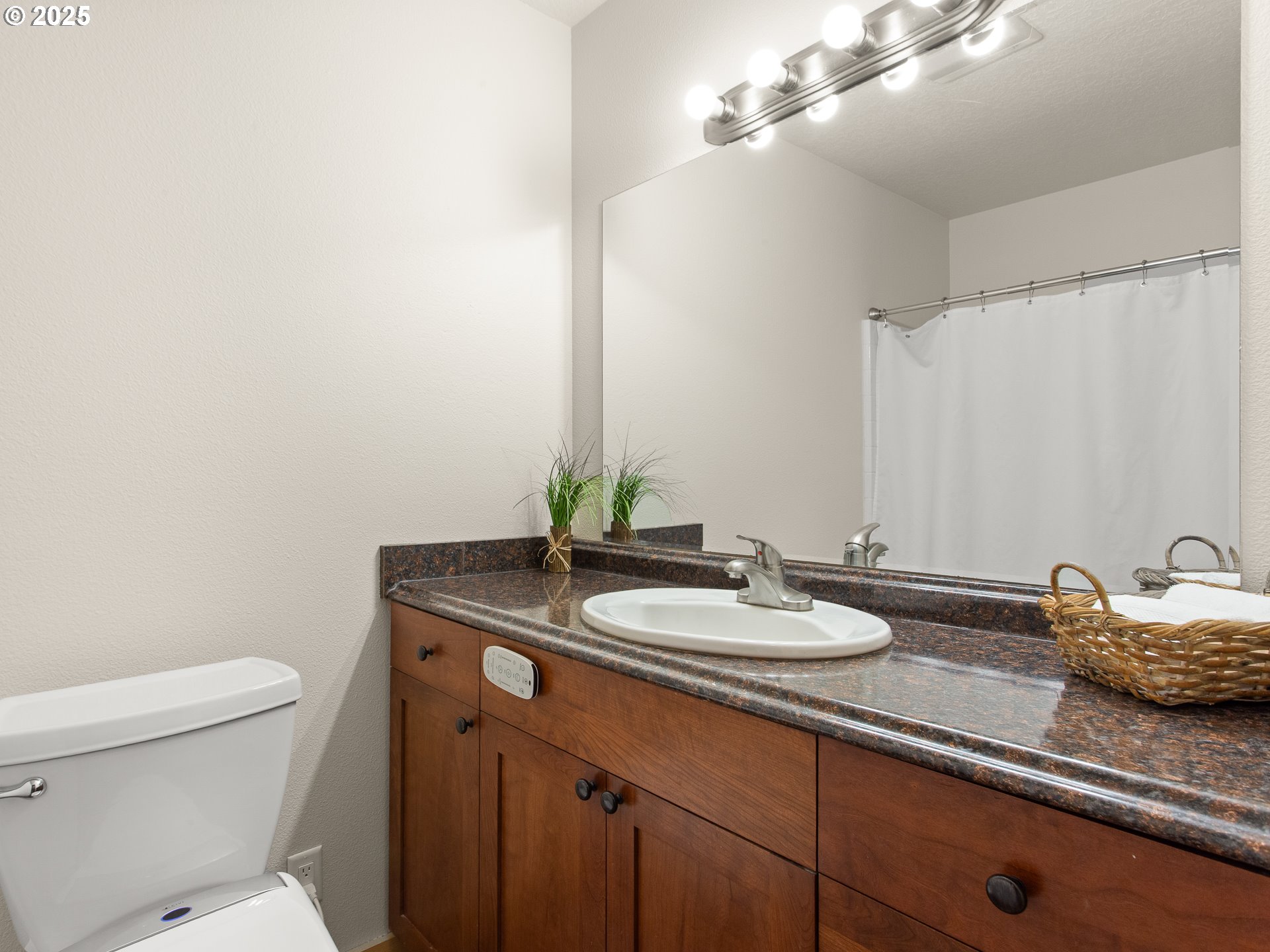 25520 Northeast 58th Street Vancouver, WA 98682 - Photo 33 of 48 a bathroom with a granite countertop sink a toilet and a mirror