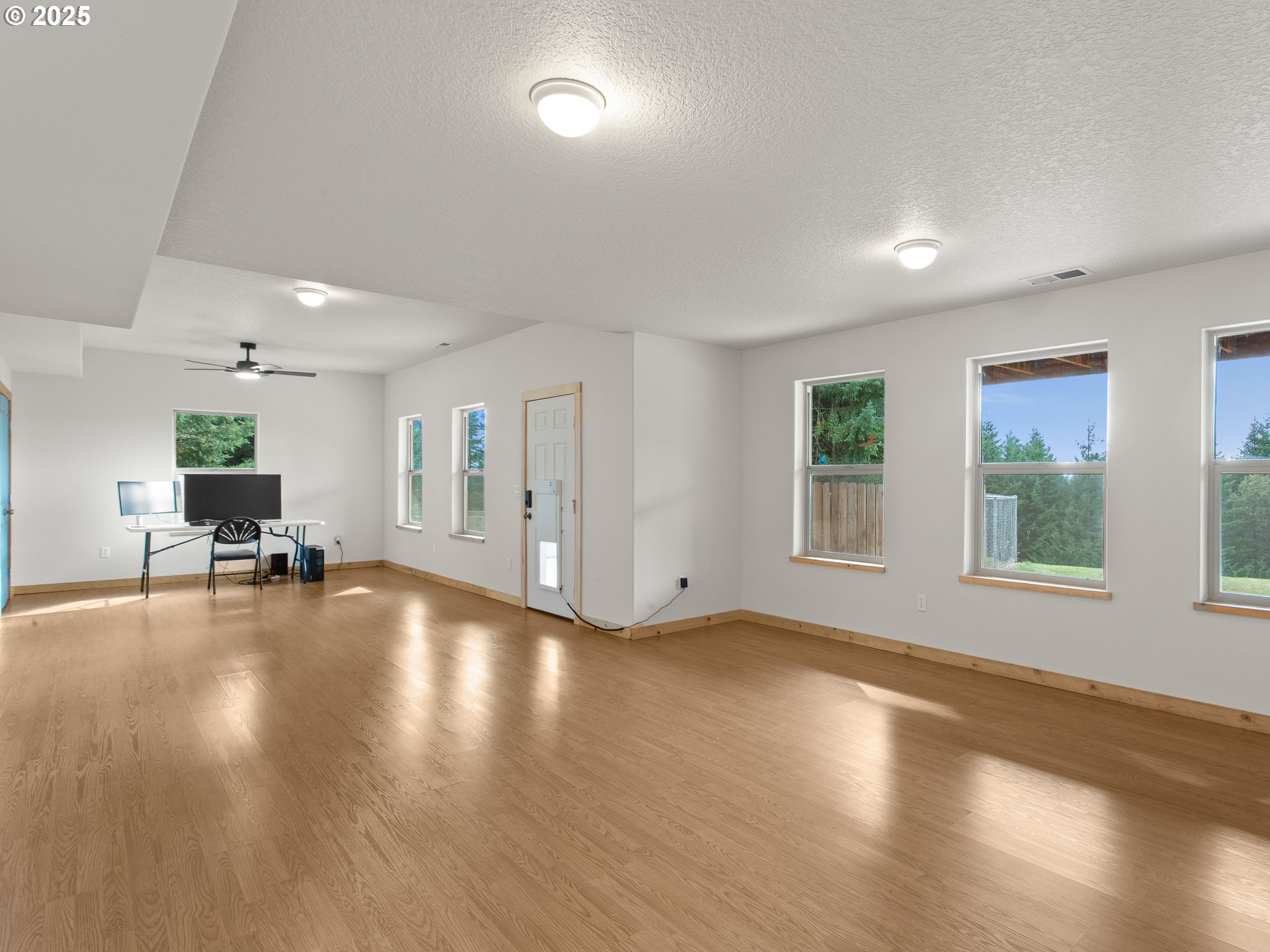 25520 Northeast 58th Street Vancouver, WA 98682 - Photo 35 of 48 a view of empty room with wooden floor and floor to ceiling window