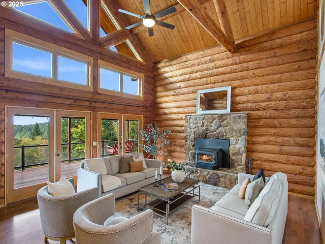 a living room with furniture a fireplace and a ceiling fan
