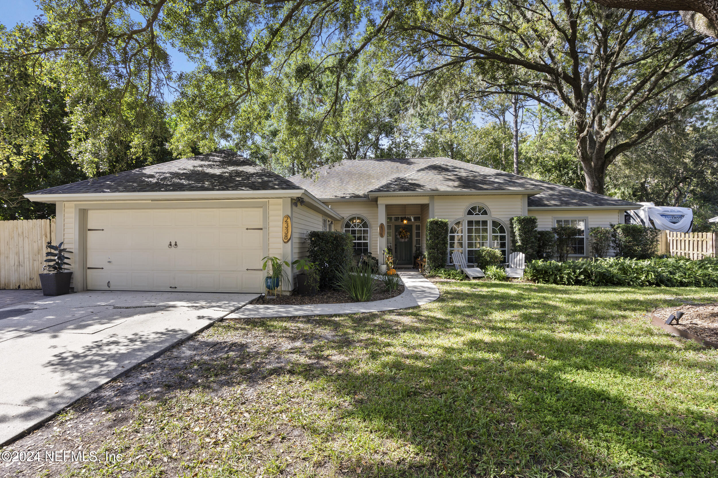 a front view of a house with a garden