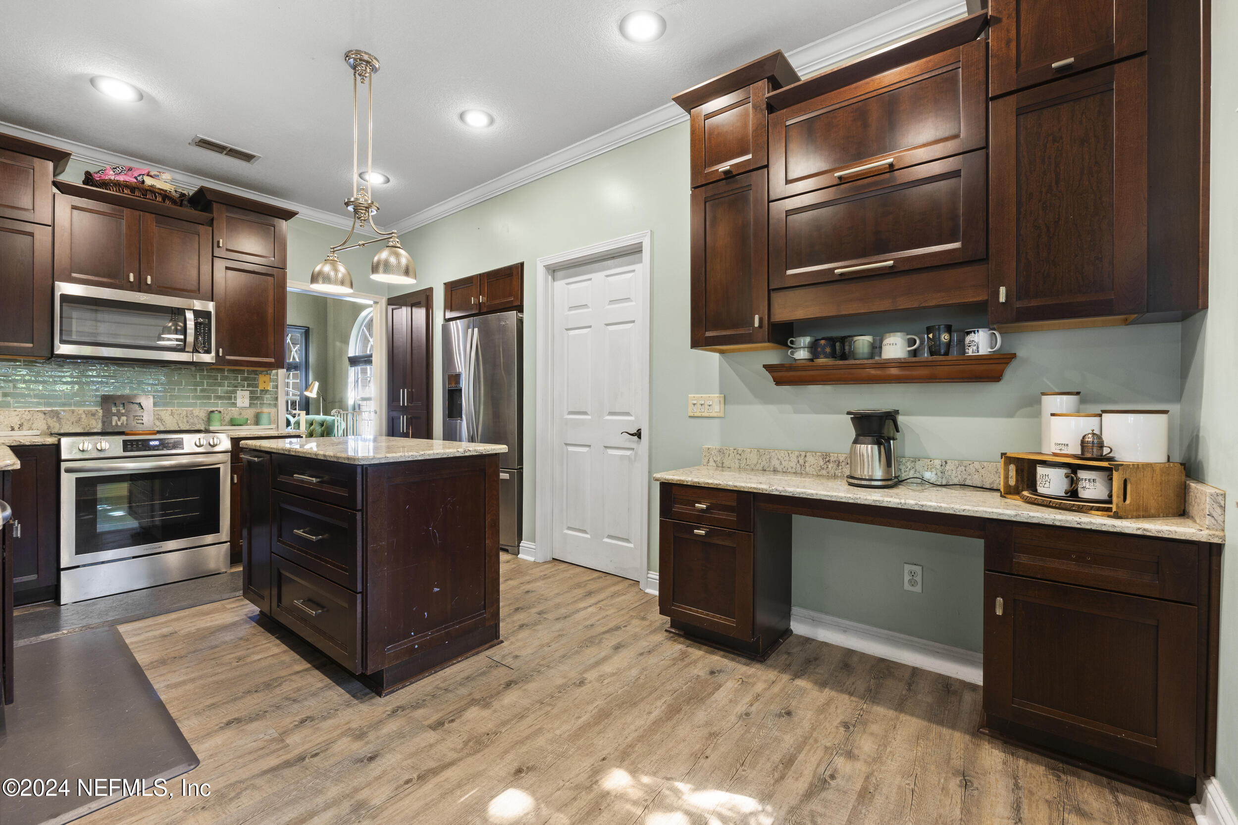 2338 Eagles Nest Road Jacksonville, FL 32246 - Photo 12 of 68 a kitchen with stainless steel appliances granite countertop a stove a sink and a microwave