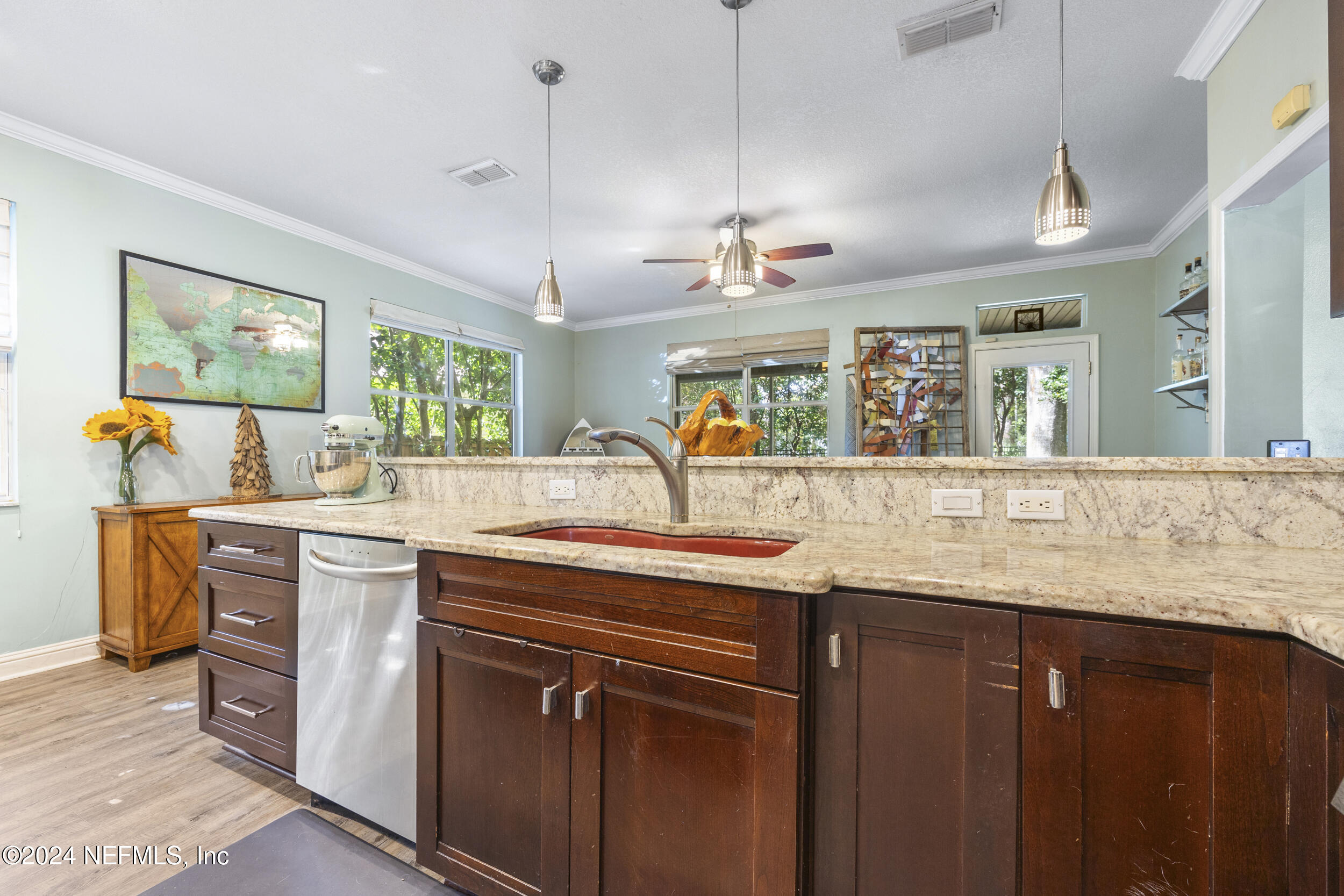2338 Eagles Nest Road Jacksonville, FL 32246 - Photo 14 of 68 a kitchen with kitchen island granite countertop a sink a counter space appliances and cabinets