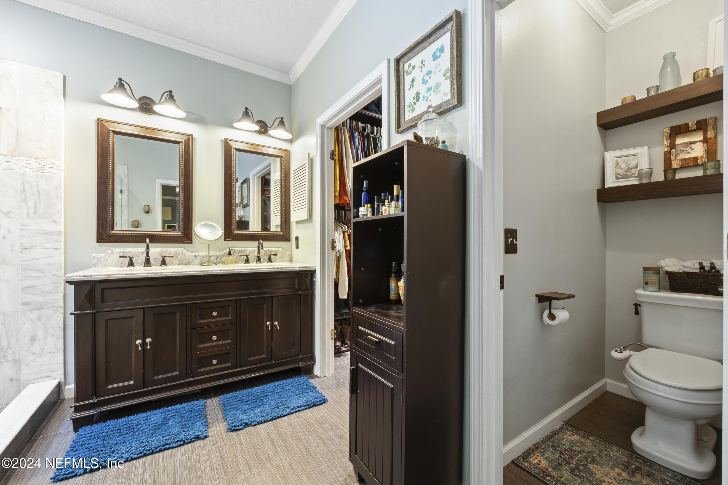 2338 Eagles Nest Road Jacksonville, FL 32246 - Photo 25 of 68 a bathroom with a toilet a sink and mirror