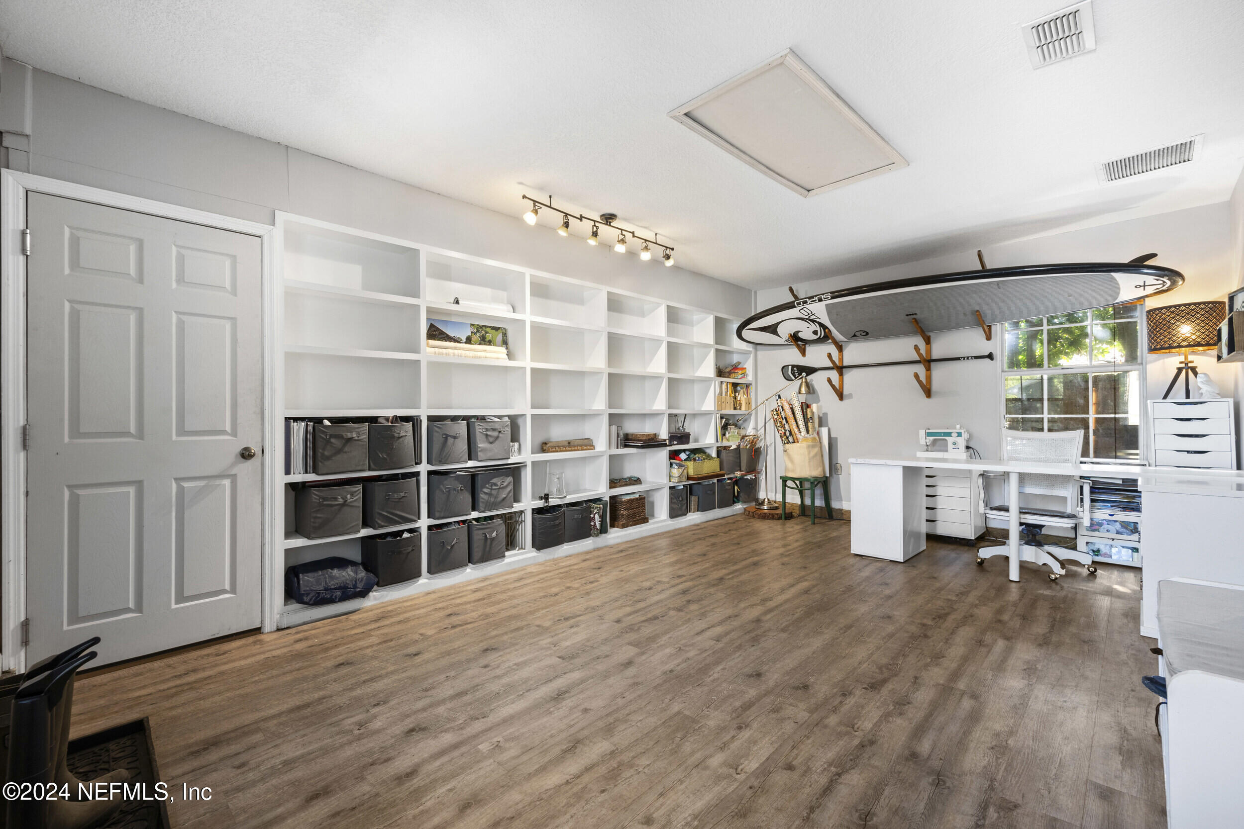 2338 Eagles Nest Road Jacksonville, FL 32246 - Photo 34 of 68 a view of empty room with wooden floor and windows