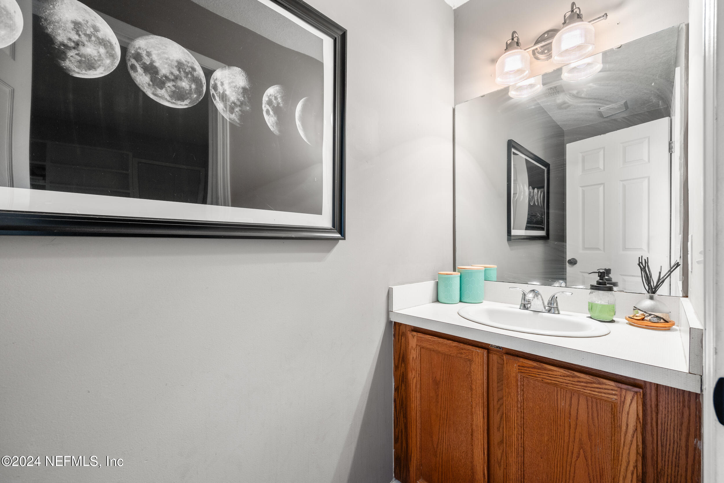 2338 Eagles Nest Road Jacksonville, FL 32246 - Photo 38 of 68 a bathroom with a sink vanity and mirror