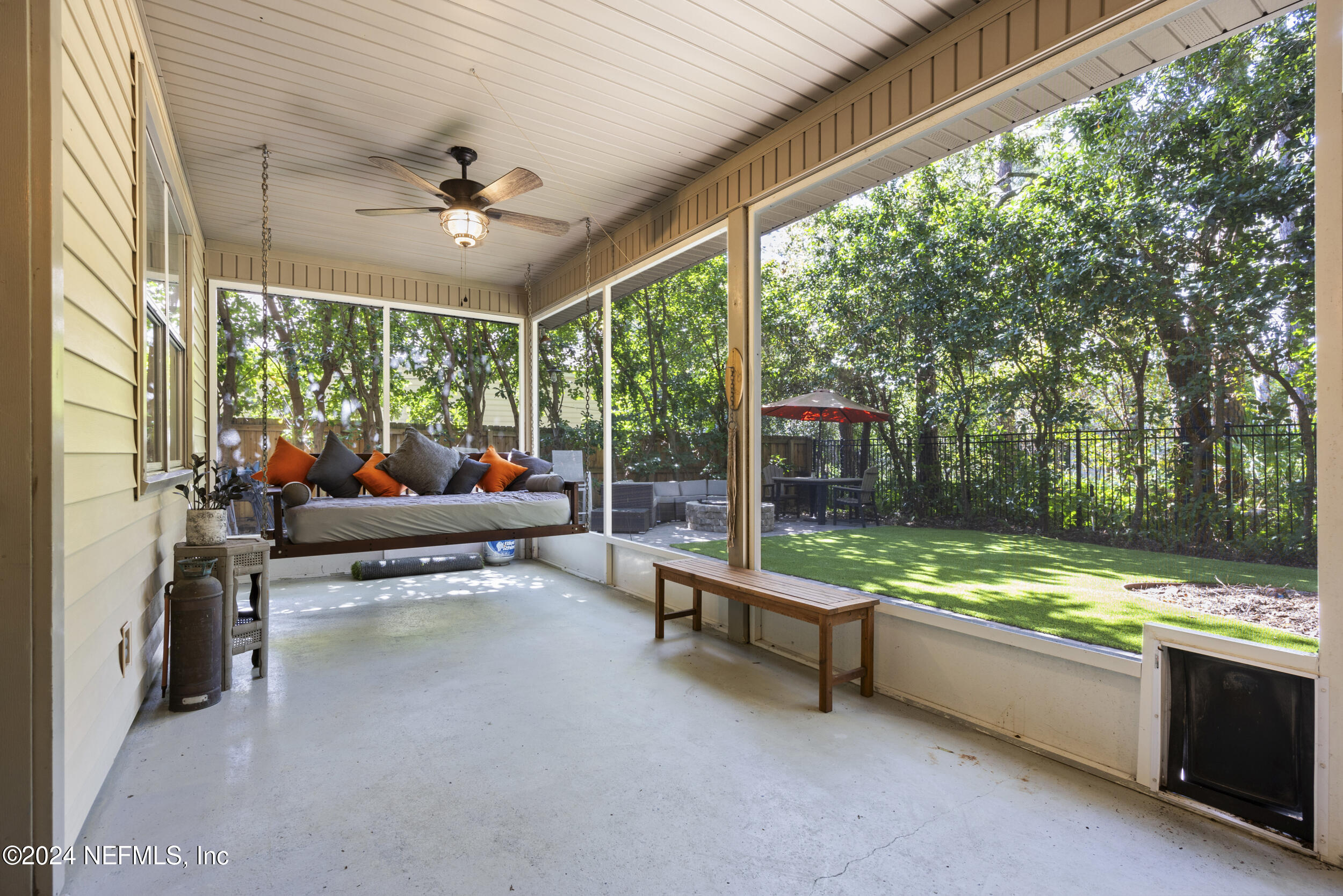 2338 Eagles Nest Road Jacksonville, FL 32246 - Photo 39 of 68 a living room with patio furniture and a yard