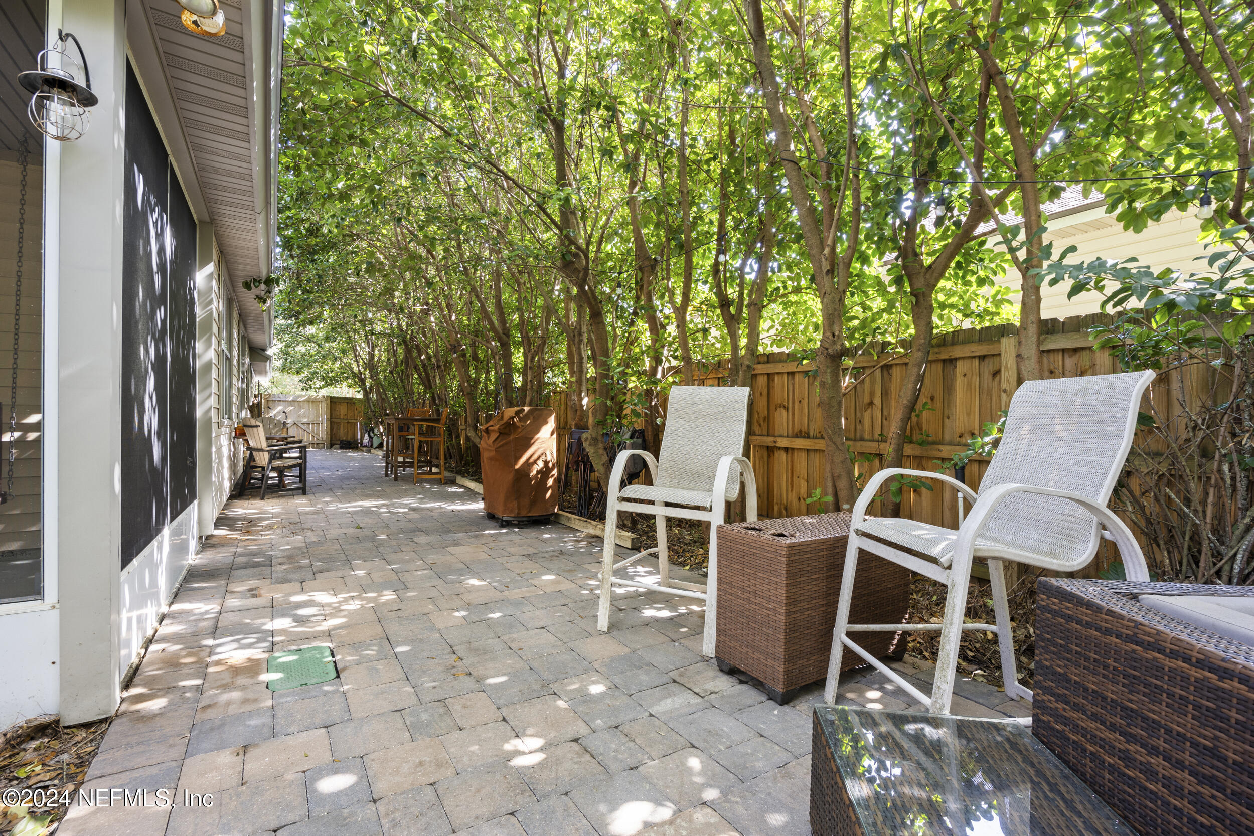 2338 Eagles Nest Road Jacksonville, FL 32246 - Photo 48 of 68 a view of a patio with table and chairs and wooden fence