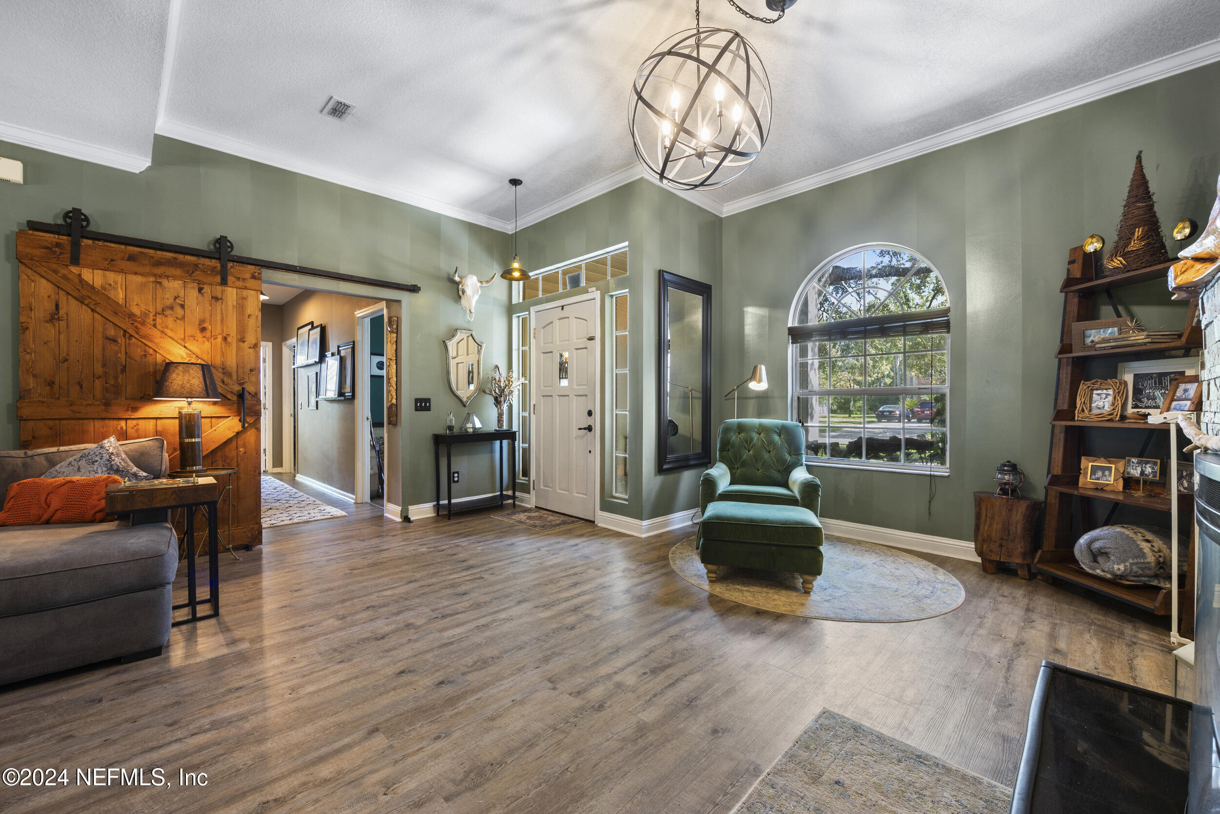 2338 Eagles Nest Road Jacksonville, FL 32246 - Photo 5 of 68 a living room with furniture a chandelier and a window