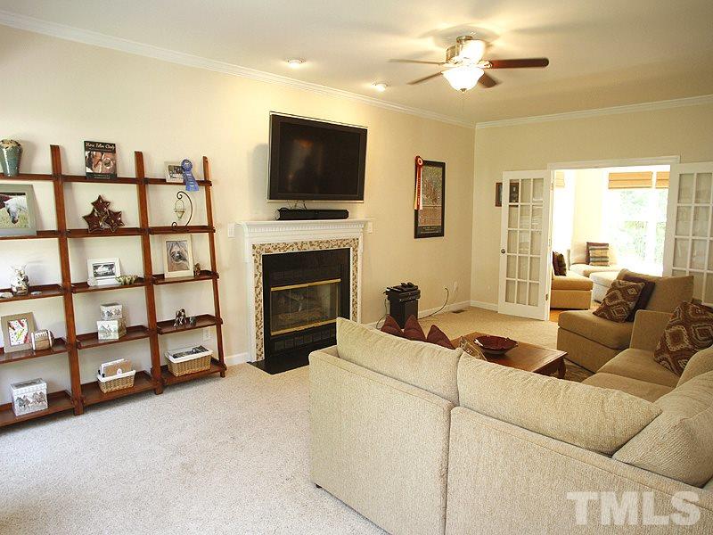 5813 Ventry Court Raleigh, NC 27613 - Photo 3 of 12 a living room with furniture and a flat screen tv