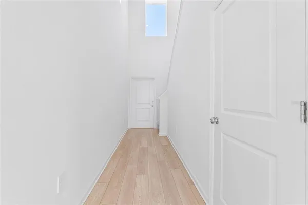 a view of a hallway with wooden floor