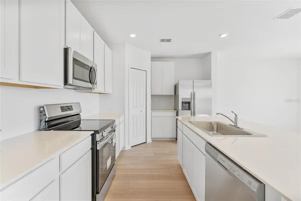 a kitchen with granite countertop a sink and a stove top oven