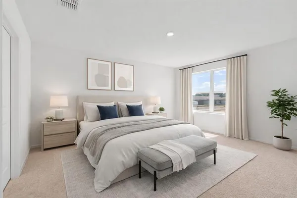 a bedroom with a bed and window
