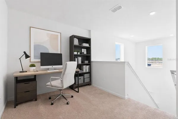 a view of a workspace with furniture