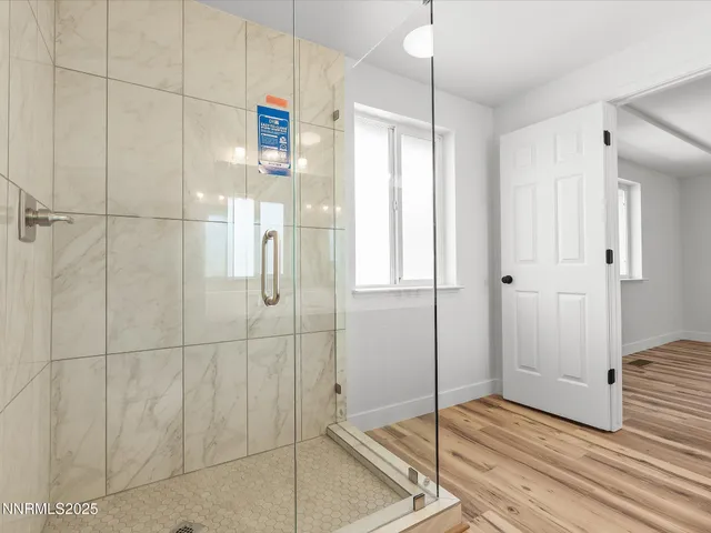 a bathroom with a shower and a sink