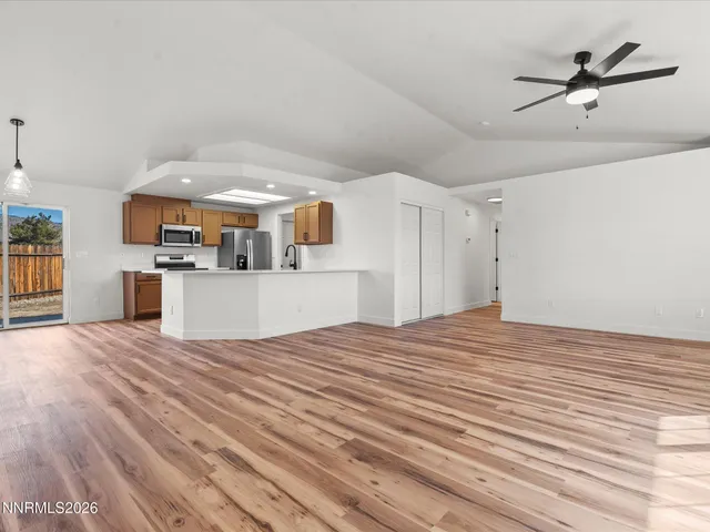 a view of a kitchen with furniture and wooden floor