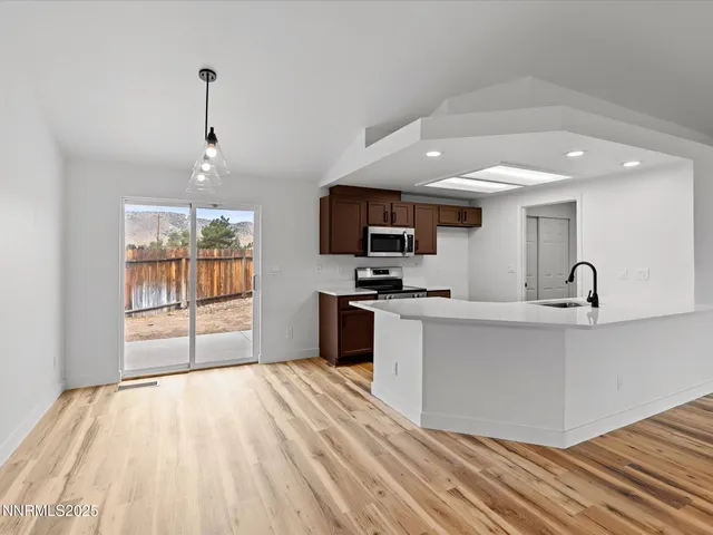 a large kitchen with kitchen island a sink stainless steel appliances and cabinets