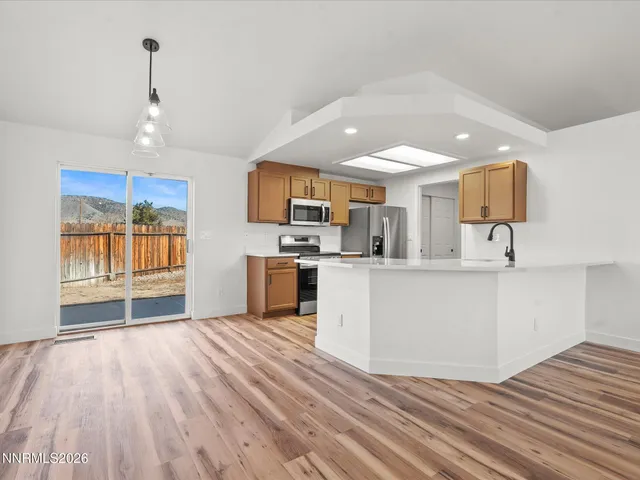 a view of a kitchen with microwave and cabinets