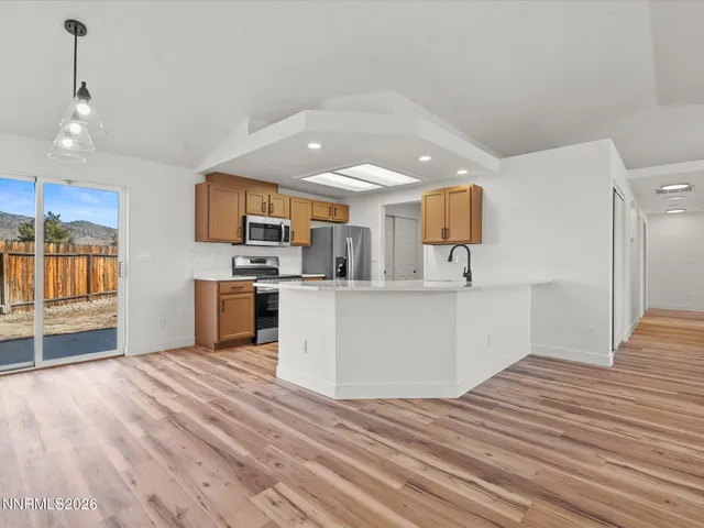 a view of kitchen with microwave and cabinets