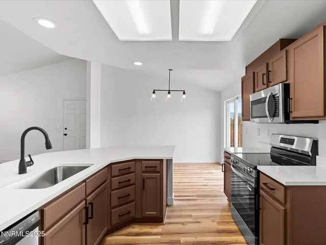 a kitchen with stainless steel appliances granite countertop a stove and a sink