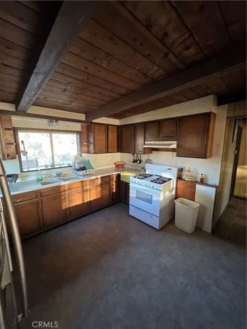 a spacious bedroom with a bed and a flat screen tv