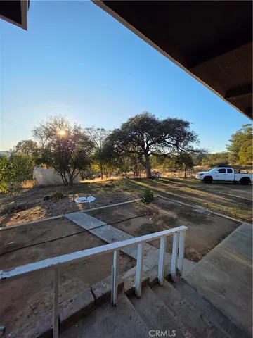 a view of yard with large trees
