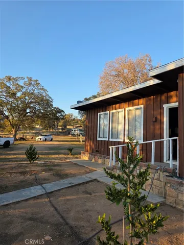 a backyard of a house with table and chairs