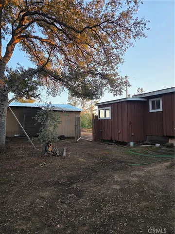 a view of a house with backyard patio and swimming pool