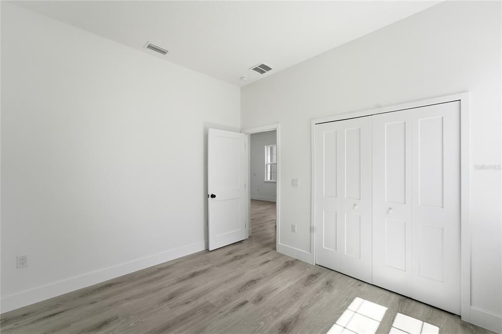 2600 Southwest 146th Pl Road Ocala, FL 34473 - Photo 20 of 40 a view of an empty room with wooden floor