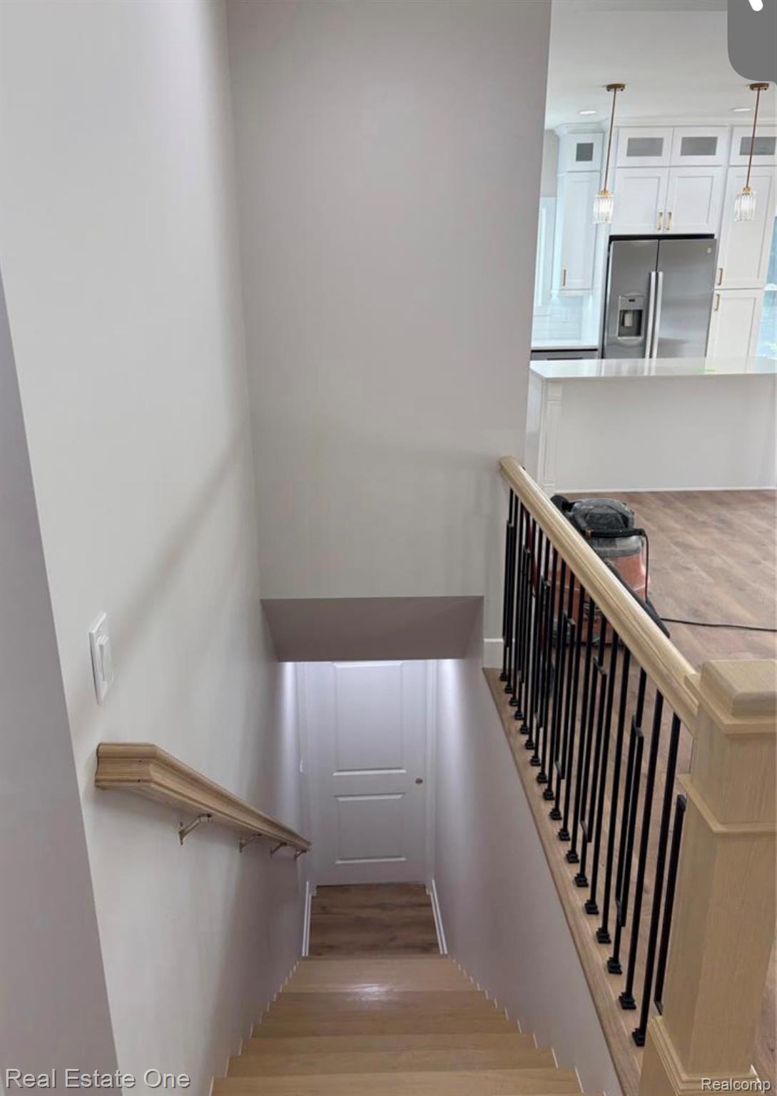 5636 Paris Street Sterling Heights, MI 48310 - Photo 19 of 37 Stairs with wood finished floors