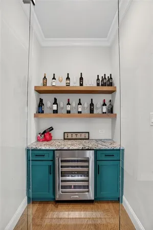 a kitchen with stainless steel appliances granite countertop a sink a stove and a wooden cabinets