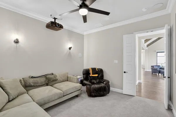 a living room with furniture and a ceiling fan