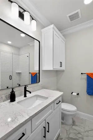 a bathroom with a toilet a sink and mirror