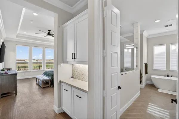 a en suite bathroom with a granite countertop tub and a large window