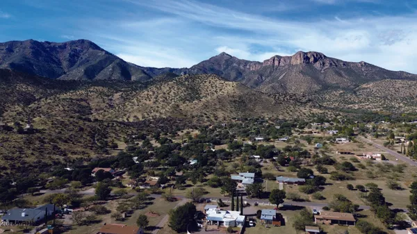 a view of a house with a mountain in the background