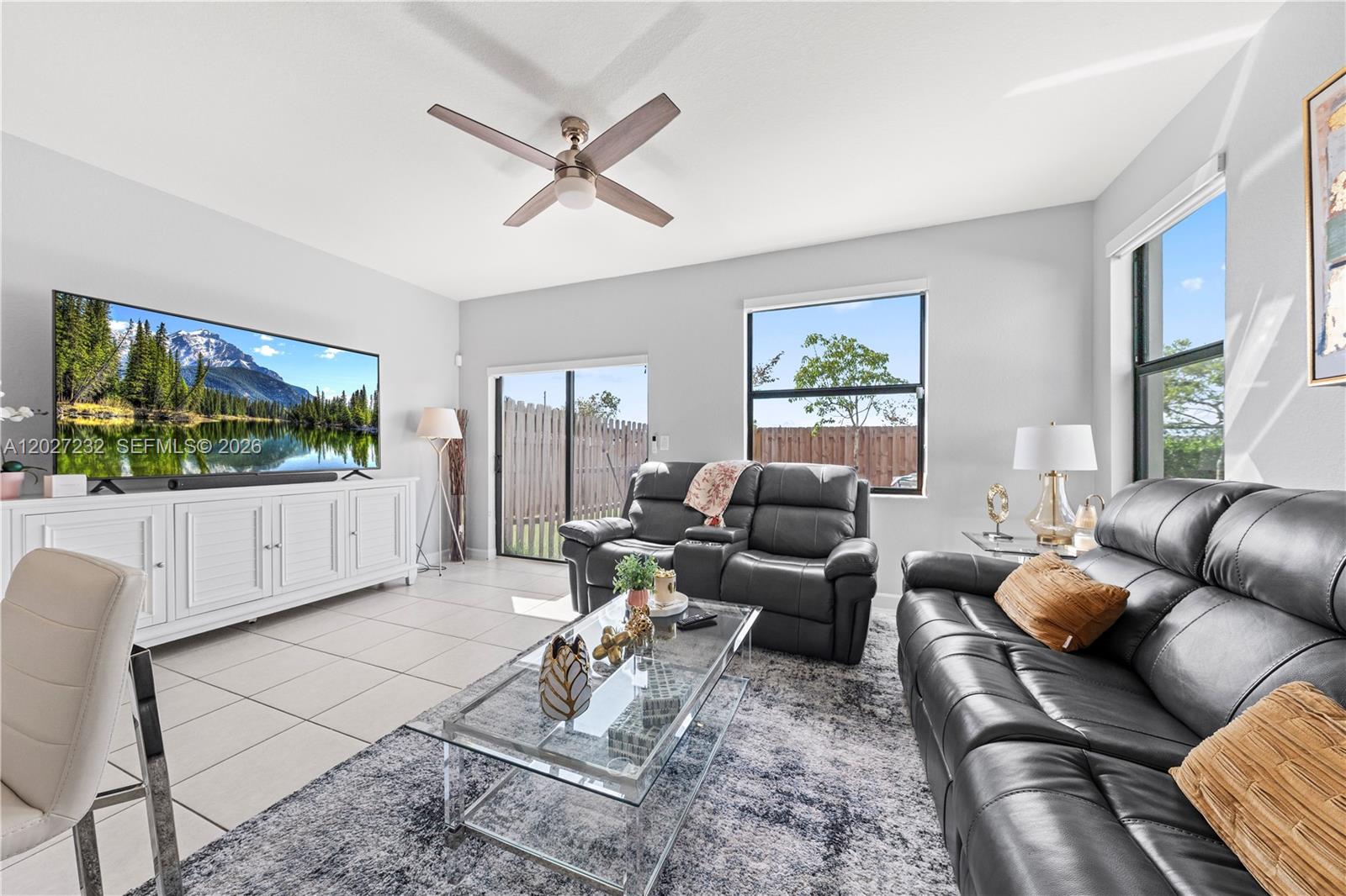 23489 Southwest 127th Place Homestead, FL 33032 - Photo 10 of 24 a living room with furniture a flat screen tv and a large window