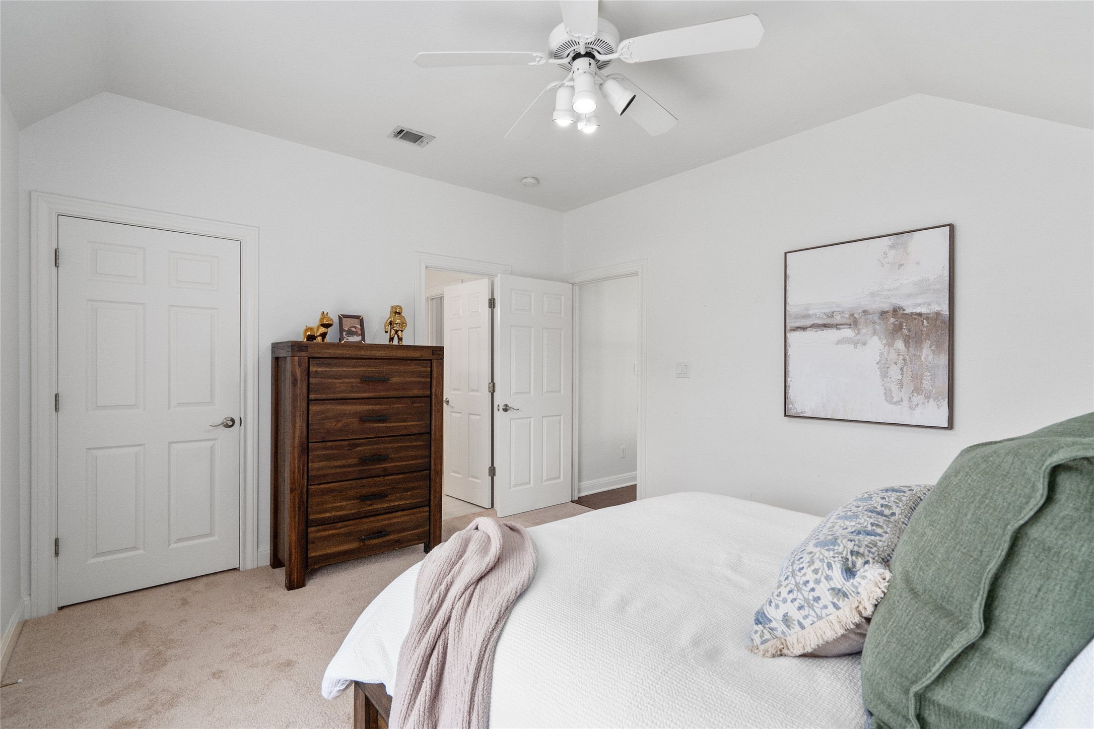 4313 Rio Robles Drive Austin, TX 78746 - Photo 30 of 40 Step into a serene bedroom with plush carpeting and a convenient ceiling fan for ultimate comfort.