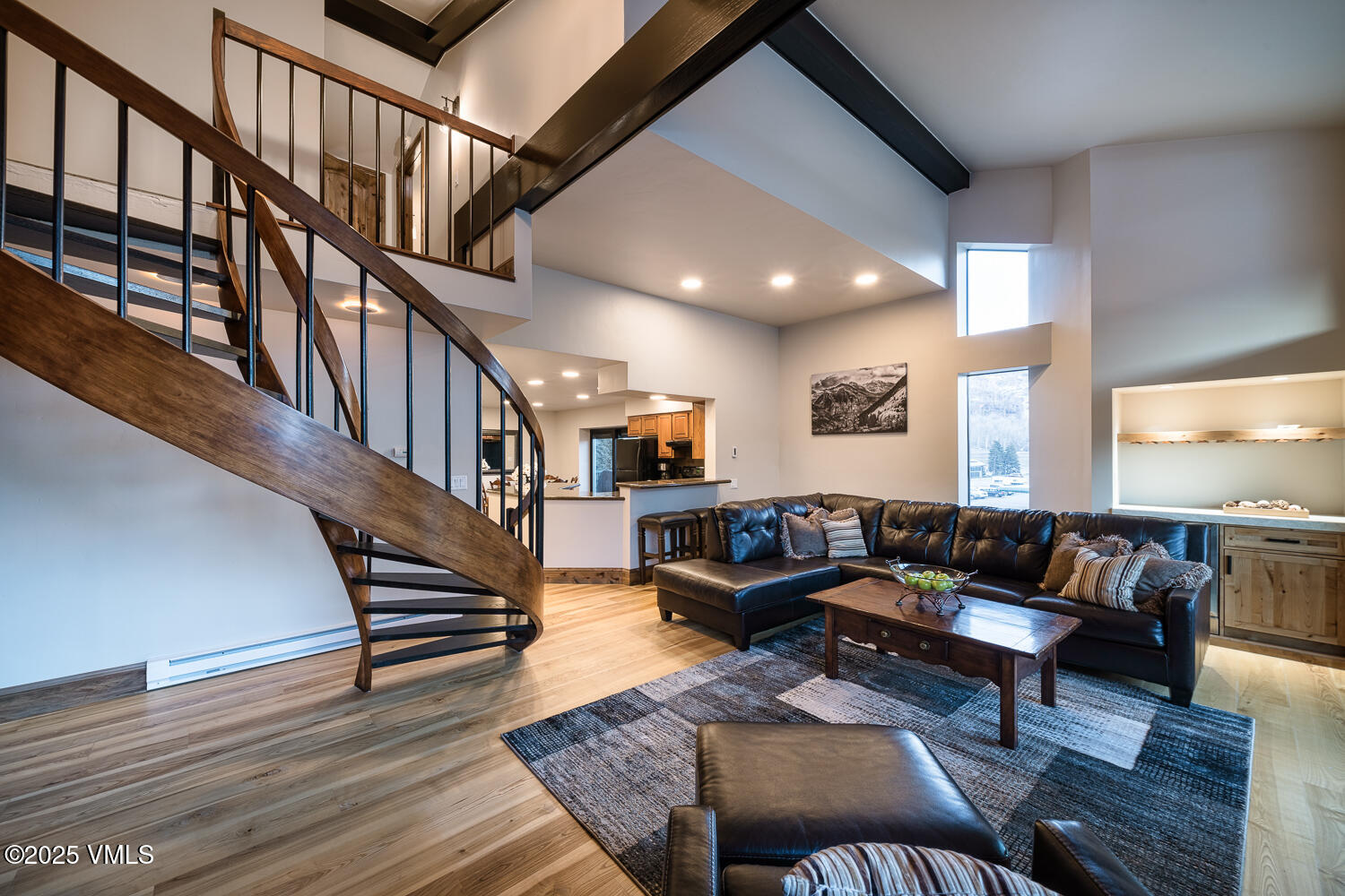 a living room with furniture or stairs and a wooden floor