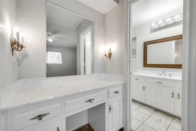 a bathroom with a sink a vanity and a mirror