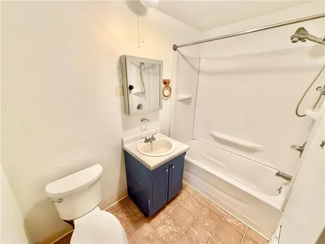 a bathroom with a sink toilet vanity and shower