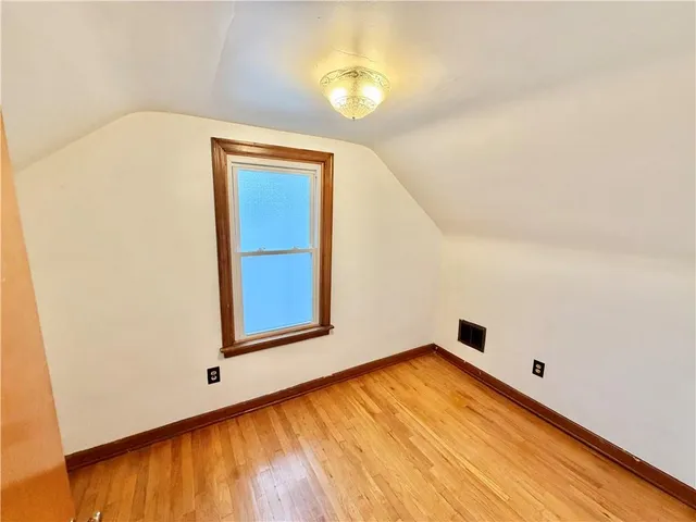 a view of a room with wooden floor and a window