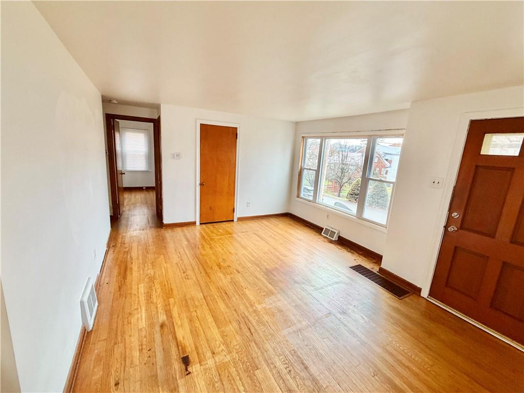 37 Kay Street Uniontown, PA 15401 - Photo 3 of 14 an empty room with wooden floor and windows