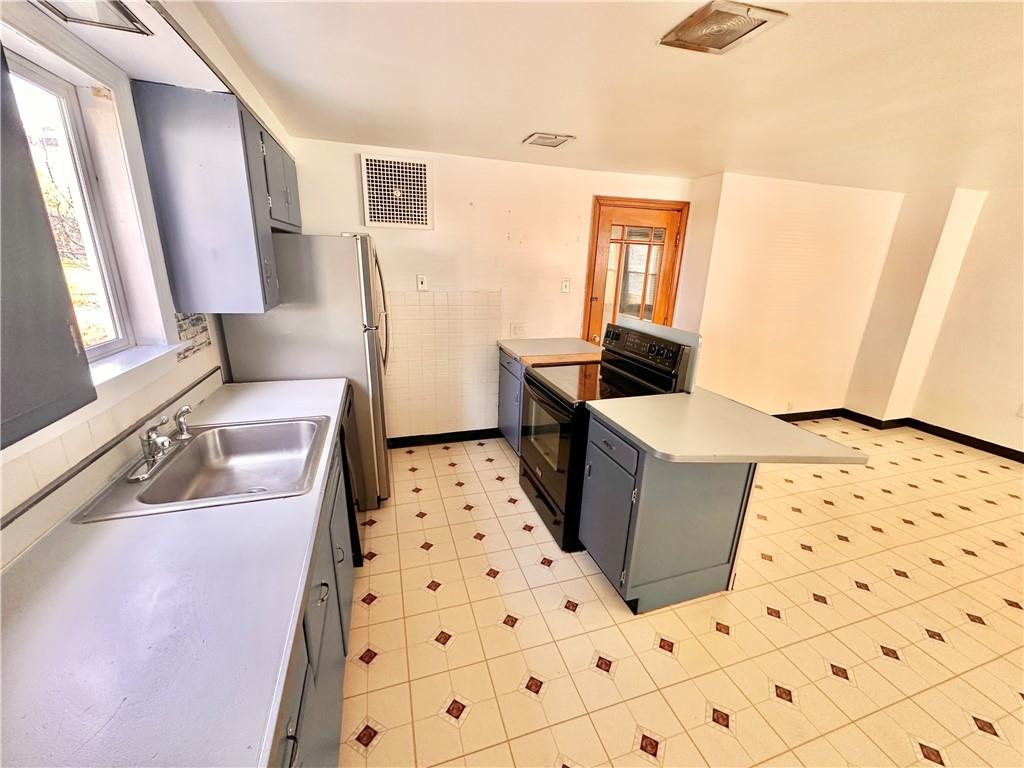 37 Kay Street Uniontown, PA 15401 - Photo 7 of 14 a living room with a couch a rug and a window