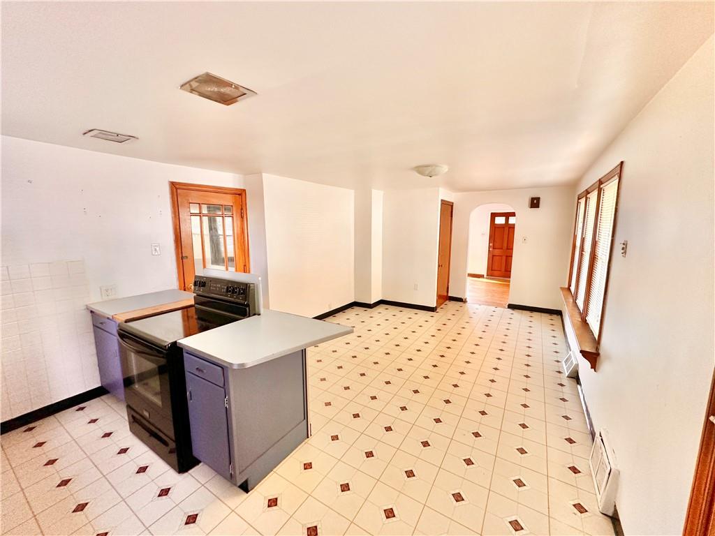 37 Kay Street Uniontown, PA 15401 - Photo 8 of 14 a hallway with a white cabinet a rug and a window