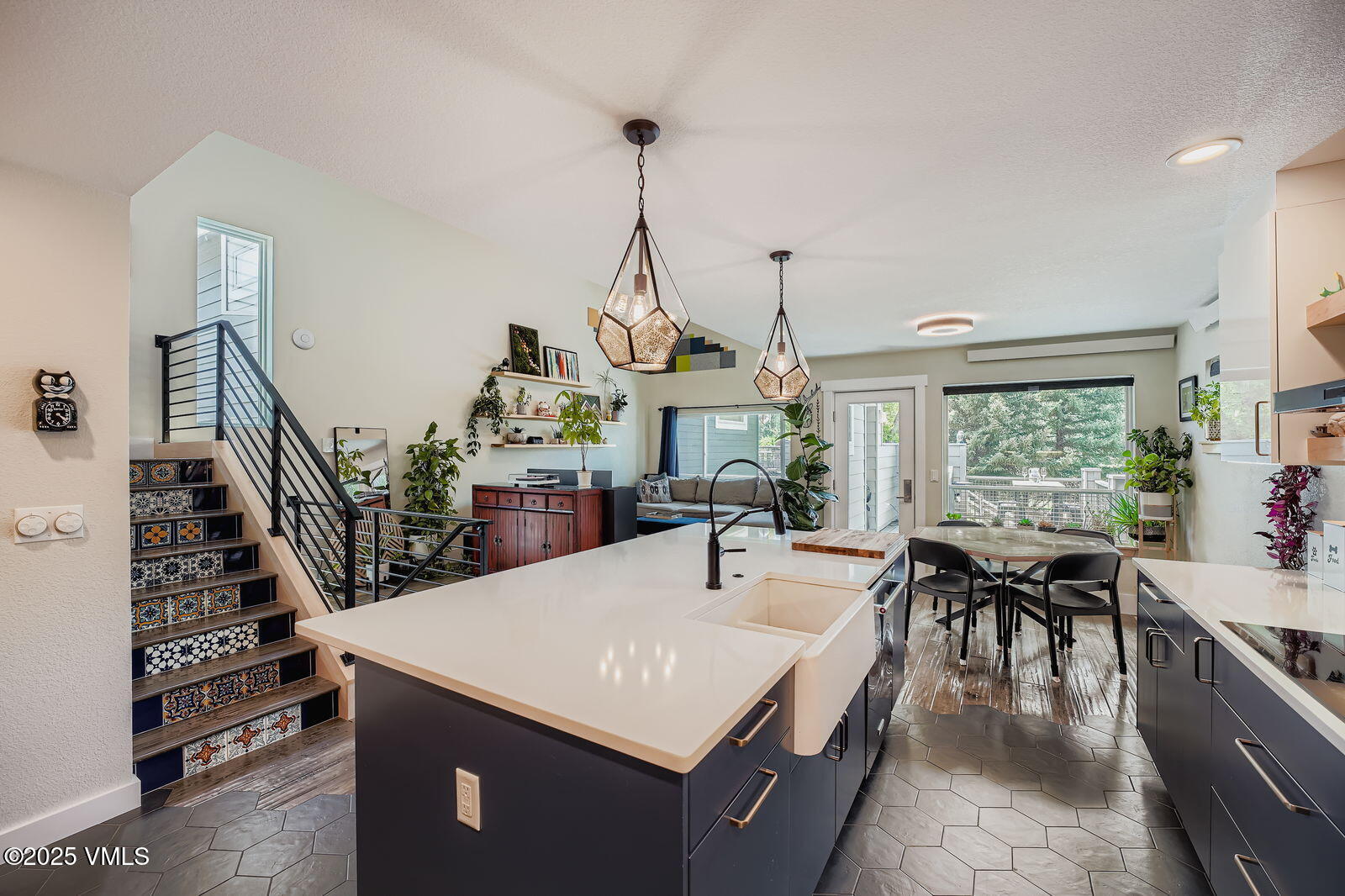 a view of a dining room and livingroom with furniture wooden floor a chandelier
