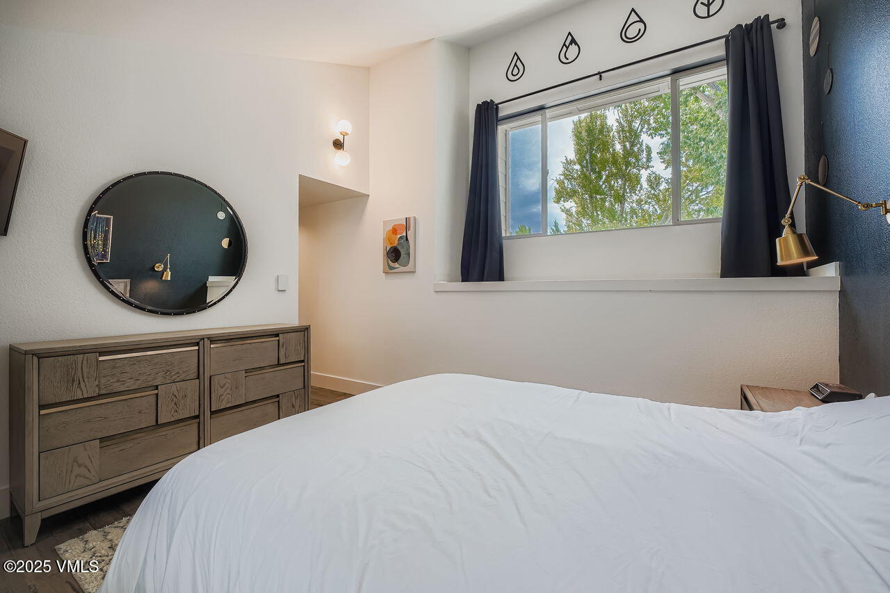 22 Wellington Lane, Unit 2 Edwards, CO 81632 - Photo 15 of 32 a bedroom with a bed and a large window