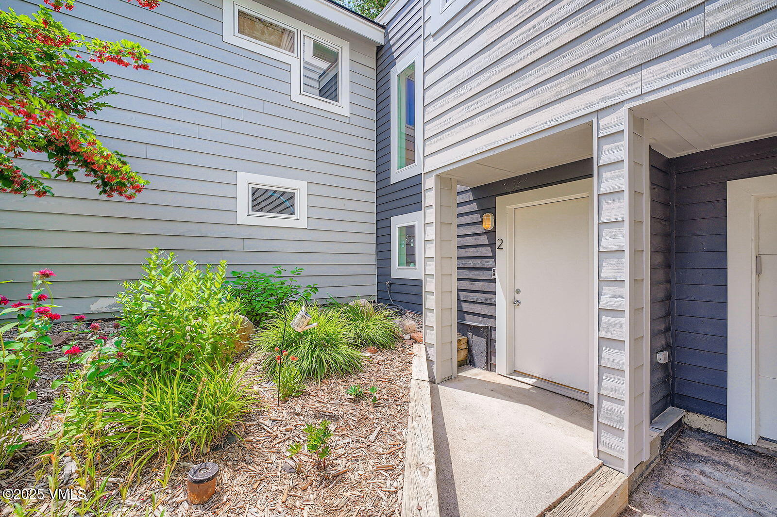 22 Wellington Lane, Unit 2 Edwards, CO 81632 - Photo 30 of 32 a potted plant sitting in front of a house