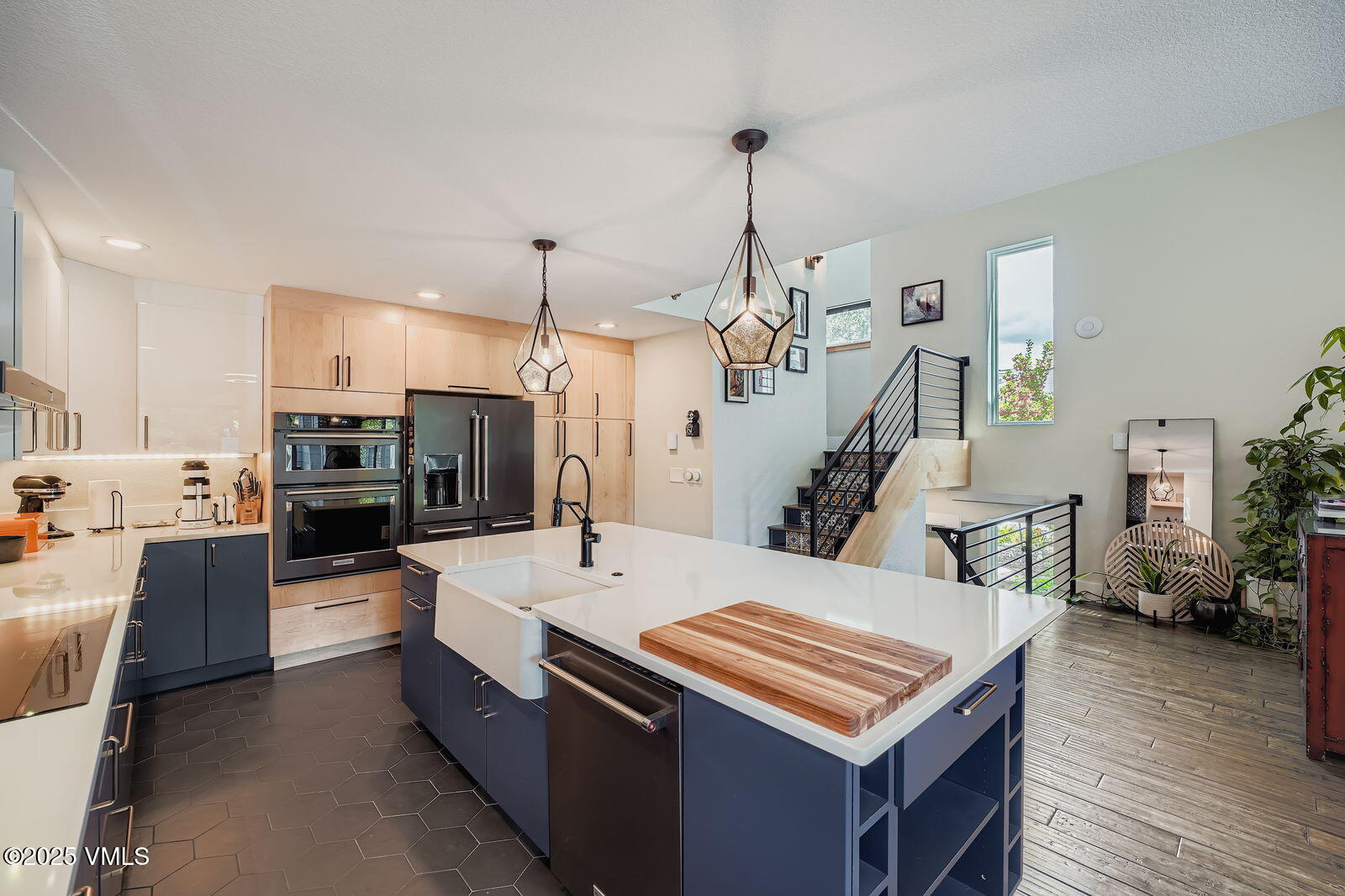 22 Wellington Lane, Unit 2 Edwards, CO 81632 - Photo 3 of 32 a large kitchen with stainless steel appliances kitchen island granite countertop a refrigerator a stove and a sink with wooden floor